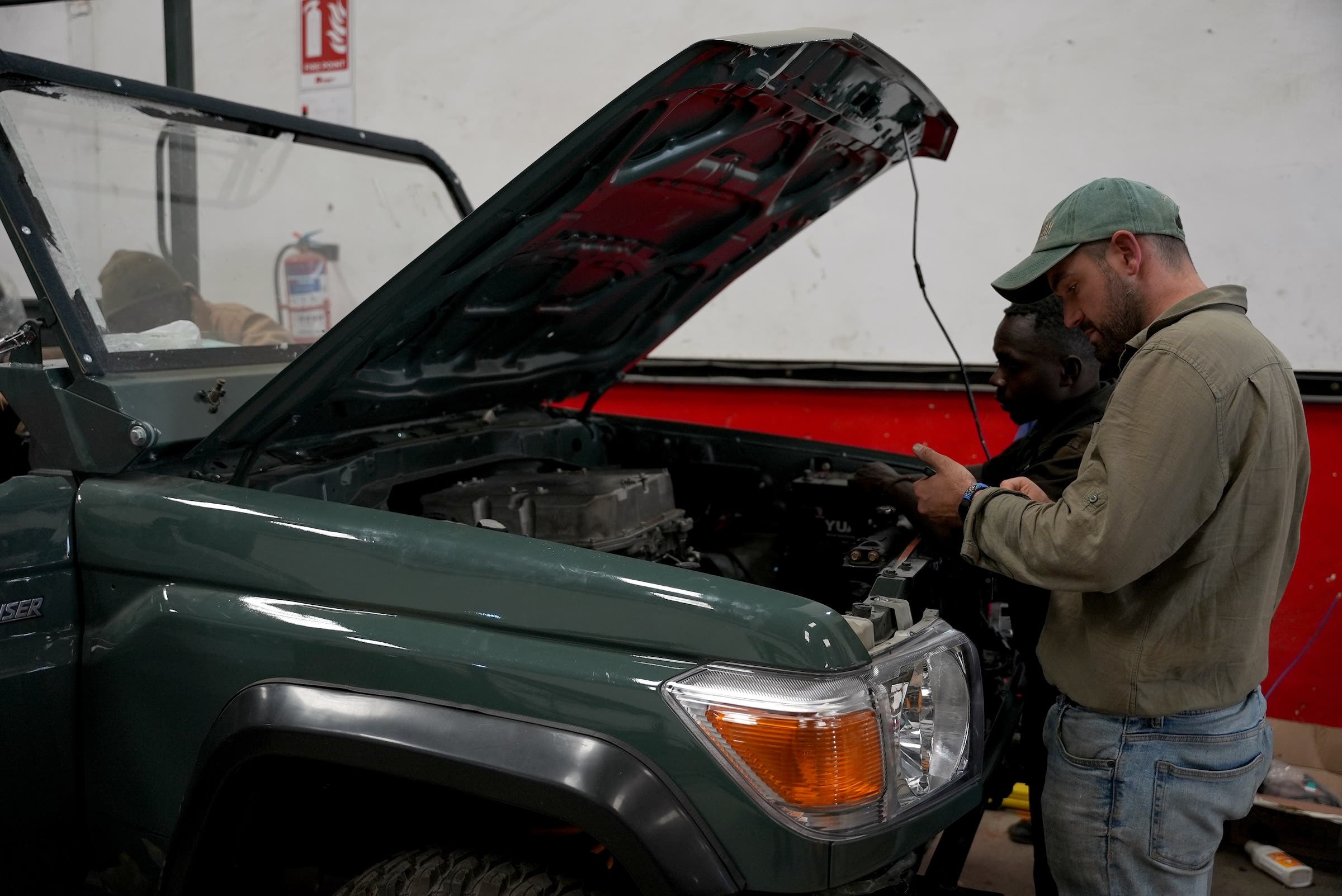 Henry Fairey, co-founder & CTO at Silent Savannah, working on converting a safari vehicle to an EV